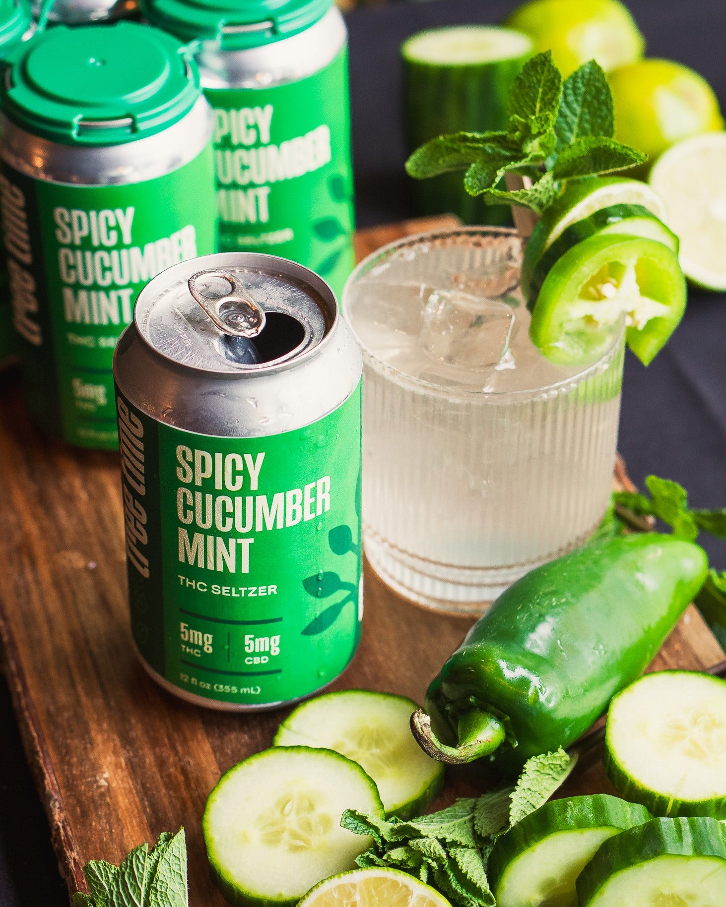 Tree Time Spicy Cucumber Mint THC seltzer with cocktail, cucumber slices, mint leaves, jalapeño, and lime – refreshing sparkling hemp drink with 5mg THC and CBD.