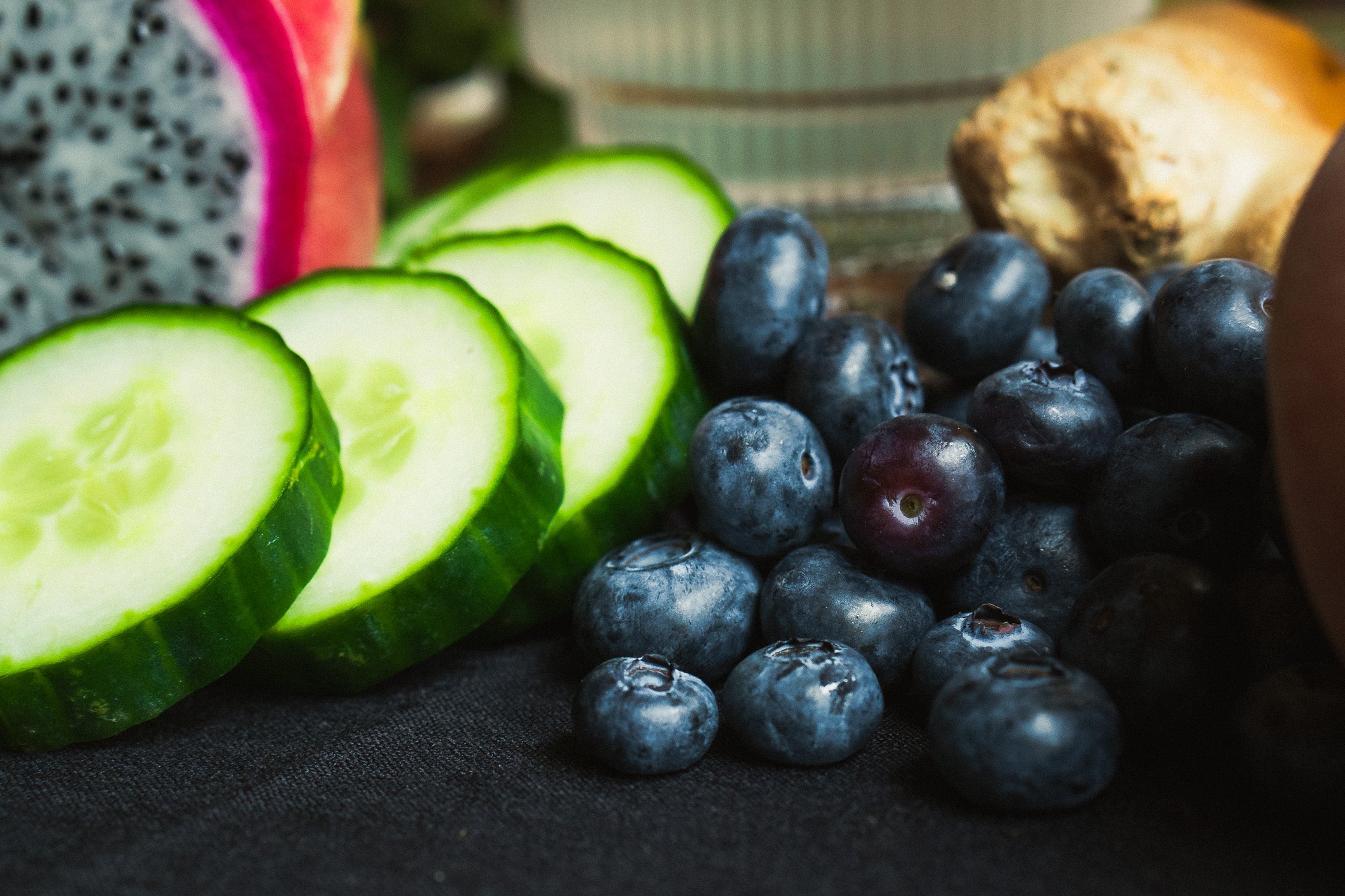 Fresh cucumber slices, ripe blueberries, dragon fruit, and ginger root – natural ingredients used in Tree Time sparkling THC seltzers.